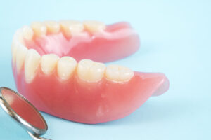 Mouth Mirror and Partial Dentures on Table